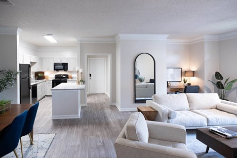 a living room filled with furniture and a large window